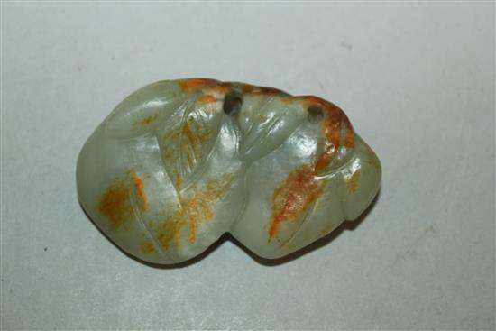 A Chinese celadon and russet jade carving of two peaches, 19th / 20th century, 6cm